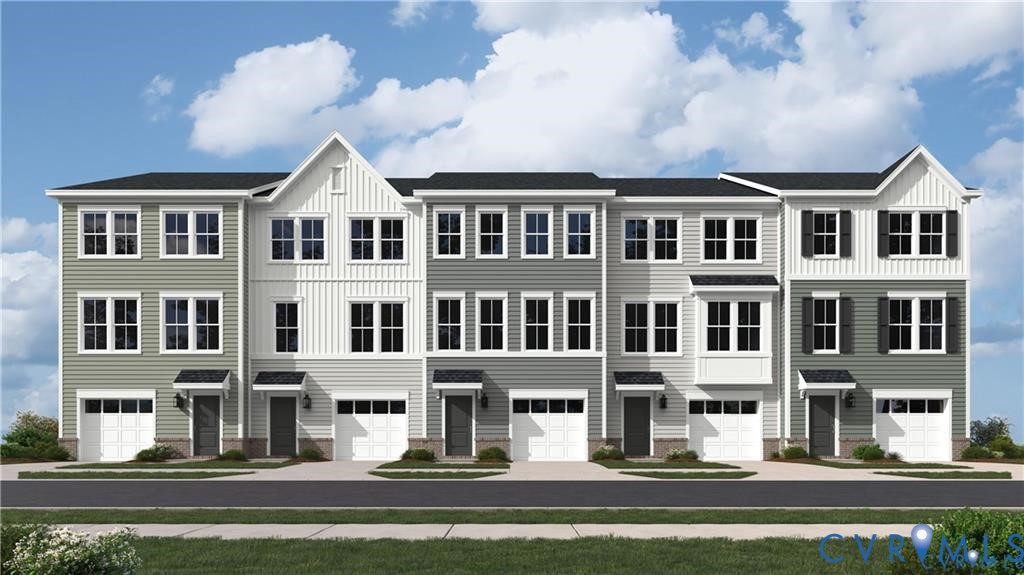 Three-story townhome exterior featuring multi-toned horizontal siding, vertical board-and-batten accents, gabled rooflines, bay windows, and private attached garages Three-story townhome exterior featuring multi-toned horizontal siding, vertical board-and-batten accents, gabled rooflines, bay windows, and private attached garages