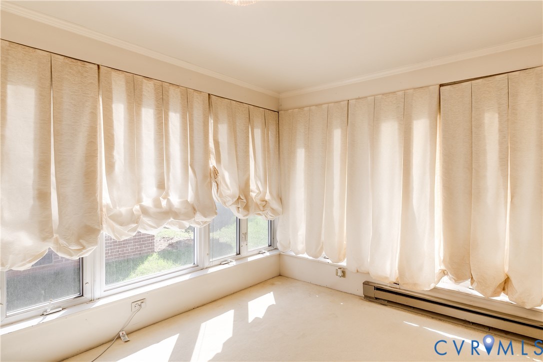 Expansive corner window configuration with multi-pane glazing and neutral carpeting