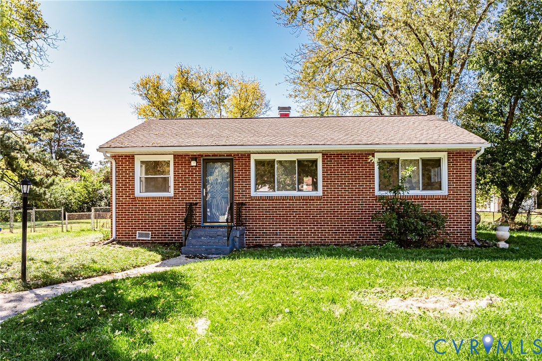 Red brick exterior featuring a pitched roof, multi-pane windows, and concrete front entry steps Red brick exterior featuring a pitched roof, multi-pane windows, and concrete front entry steps