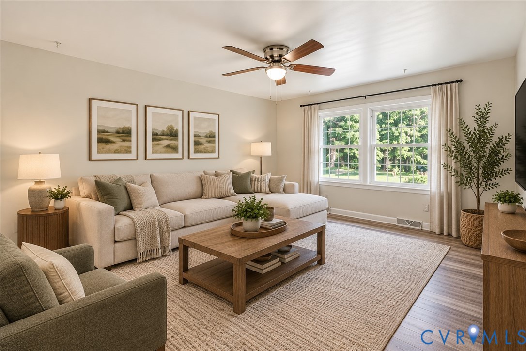 Living space featuring wood-finish flooring, dual-pane windows, and a ceiling fan with integrated light fixture, ai staged