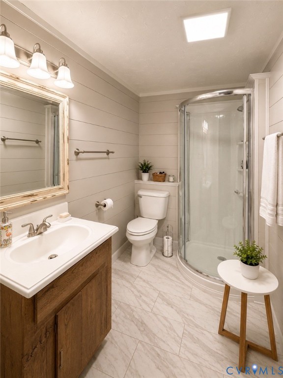 Bathroom featuring horizontal shiplap wall paneling, a wood-finish vanity with a white composite countertop, a curved glass-enclosed shower, and light-toned tile flooring