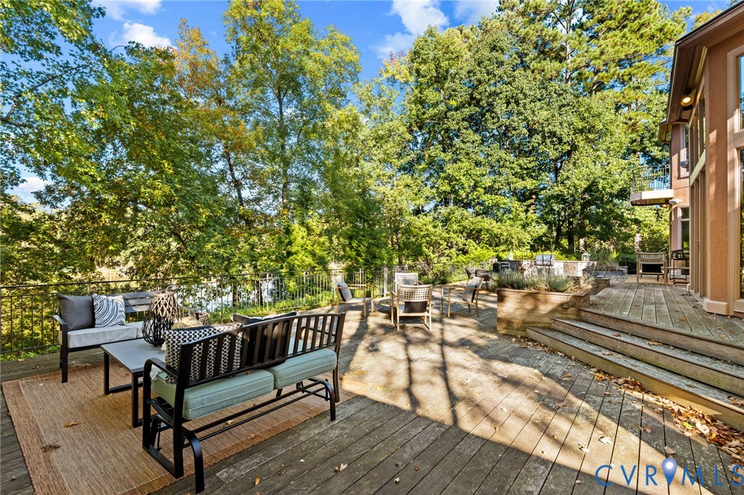 Multi-level wood deck featuring tiered stairs, built-in planter boxes, and perimeter metal railing