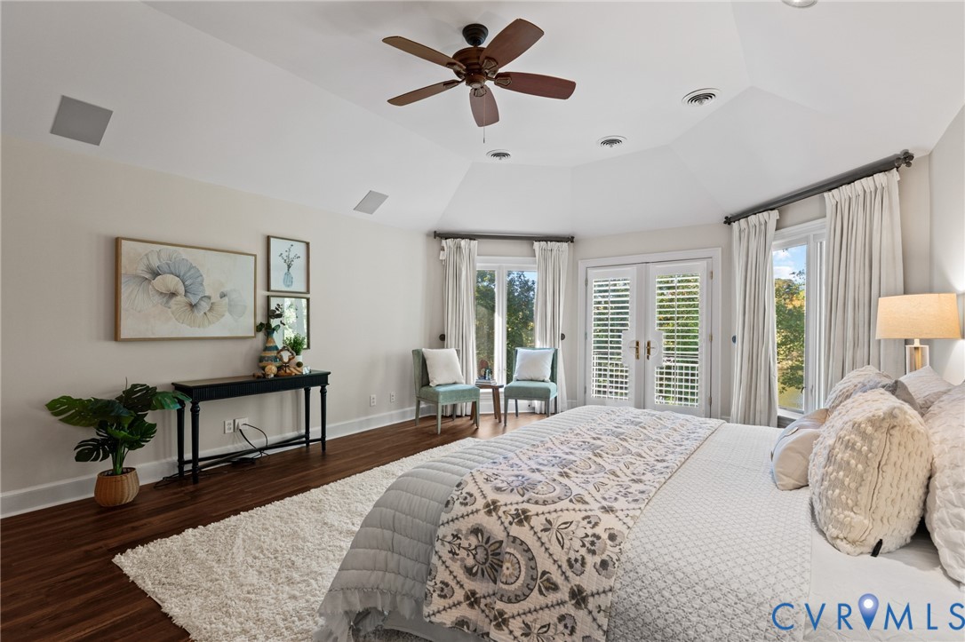 Vaulted ceilings, wood-finish flooring, ceiling fan, and French doors featuring louvered shutters