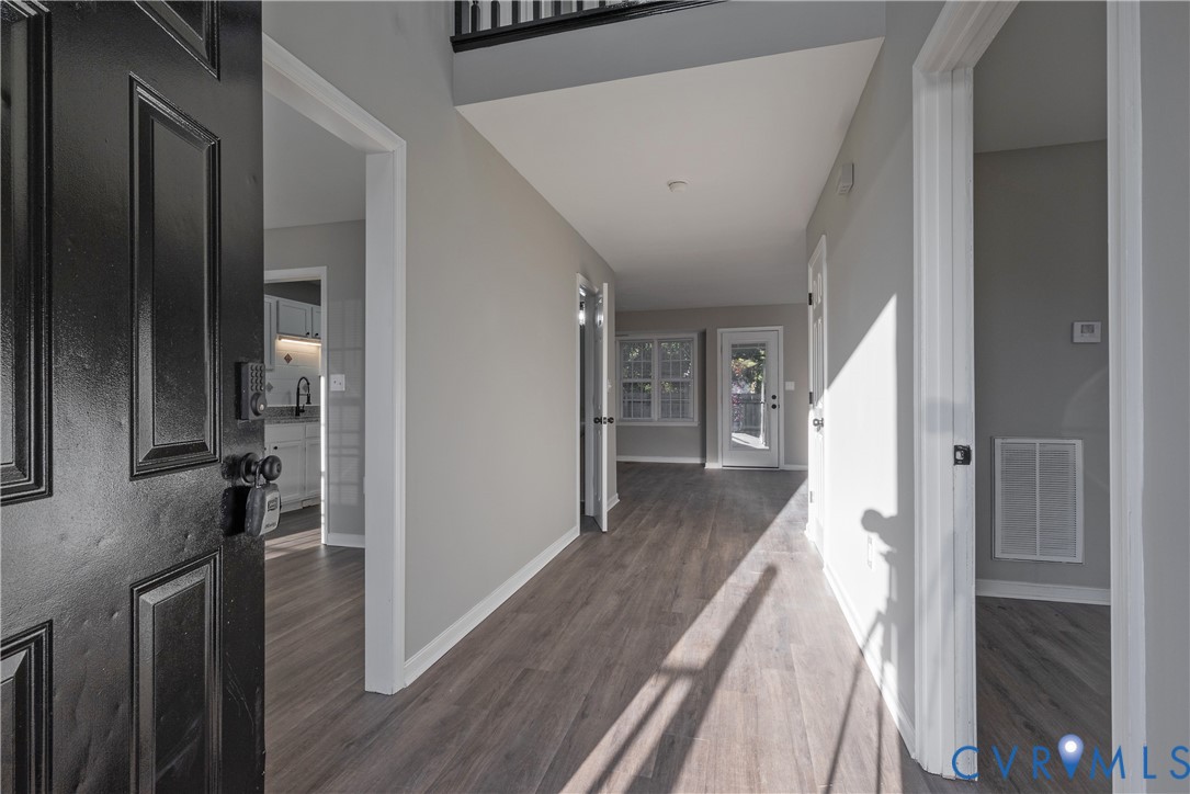 2 Story Foyer featuring new flooring, neutral interior paint, and a paneled entry door