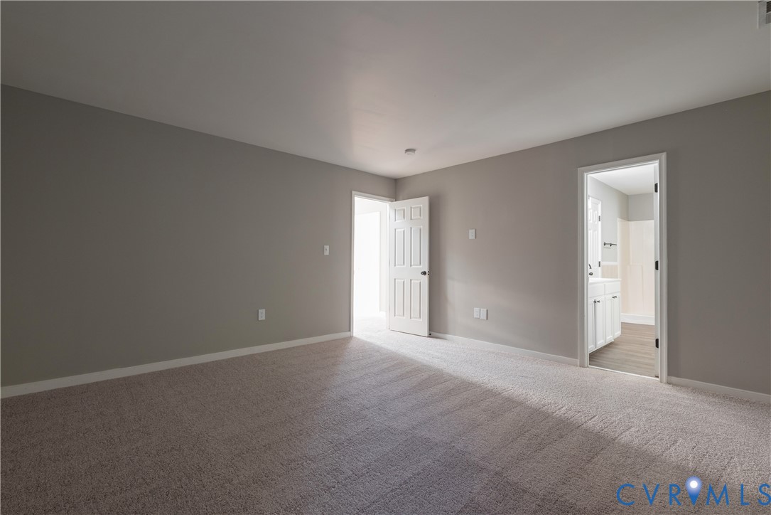 Primary Bedroom with Neutral-toned walls, wall-to-wall carpeting, and a full bath