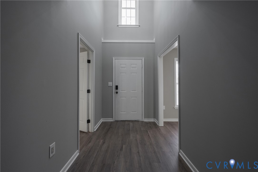 Entry with new flooring, neutral paint with 2 story foyer