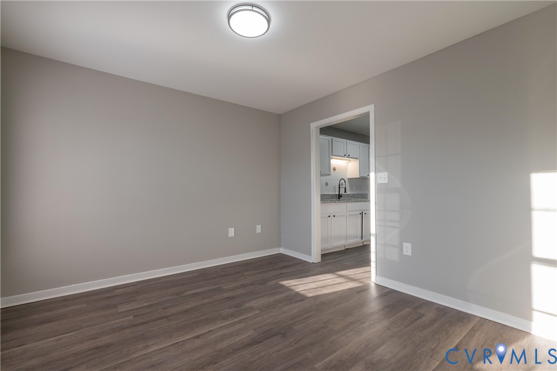 Formal Dining Room with new flooring, a contemporary flush-mount ceiling light fixture, and white trim
