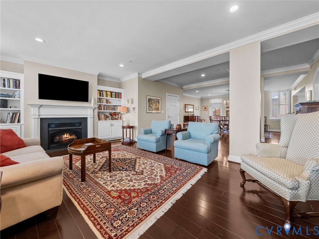 Living room with gas fireplace with mantel and flanking bookcases. Living room with gas fireplace with mantel and flanking bookcases.