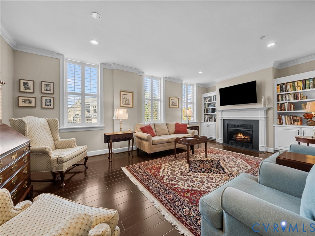 Living room has crown moulding and plantation shutters. Living room has crown moulding and plantation shutters.