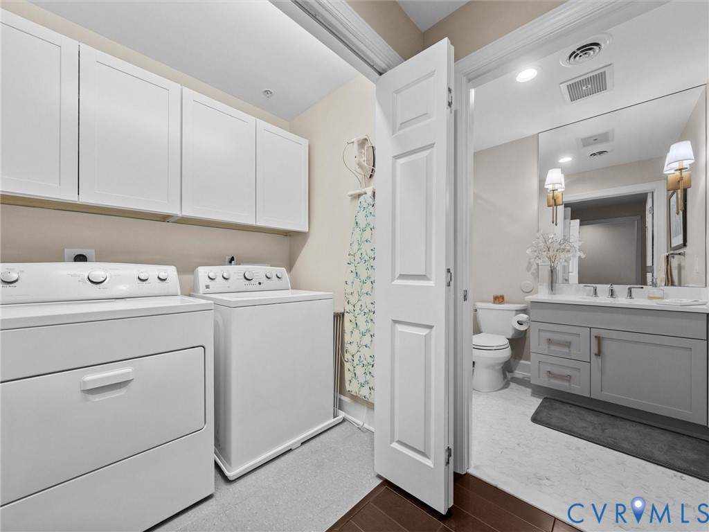 Washer and dryer conveniently located in rear hallway.