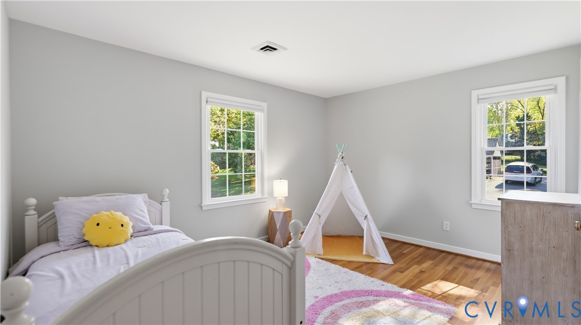 Neutral-toned walls, wood-finish flooring, and multiple double-hung windows