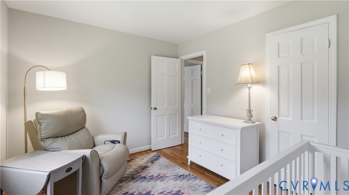 Neutral wall color, wood-finish flooring, and white six-panel interior doors
