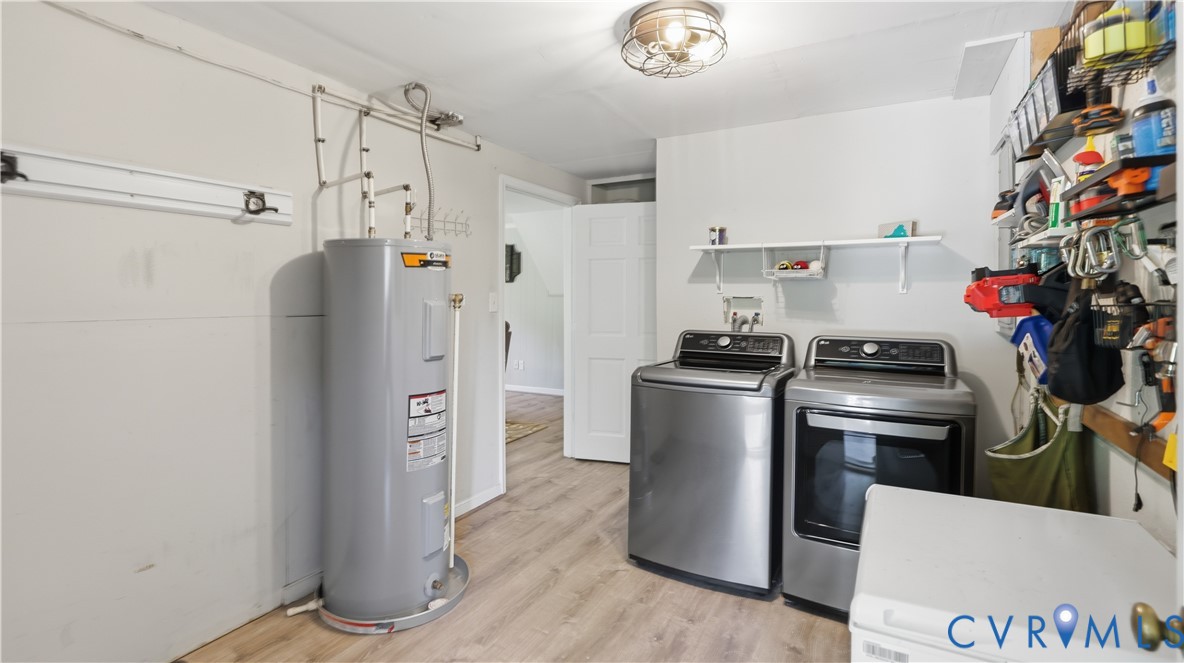 Utility space featuring wood-finish flooring, a wall-mounted floating shelf, and a flush-mount industrial-style lighting fixture