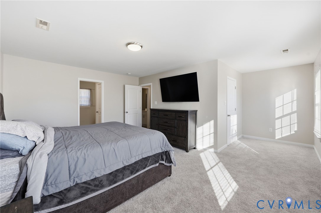 Neutral wall tones, wall-to-wall carpeting, multiple doorways, and flush-mount ceiling lighting