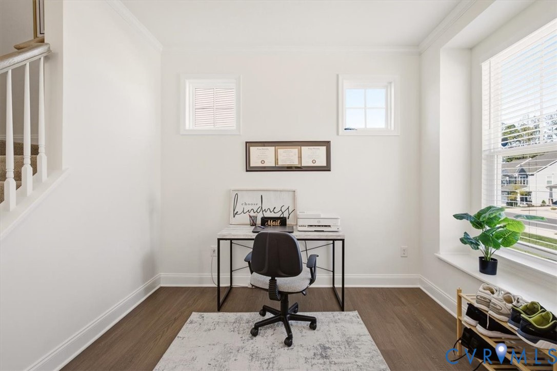 Wood-finish flooring, bay window with integrated ledge, and dual square accent windows