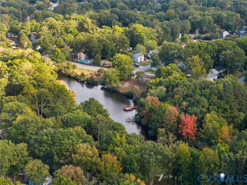 Aerial perspective featuring a body of water, wooded landscape, and a wooden dock