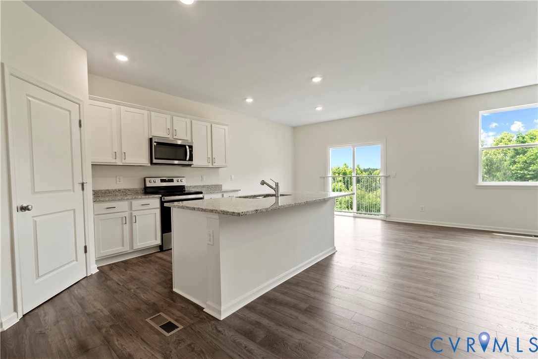 Open-concept living space featuring wood-finish flooring throughout