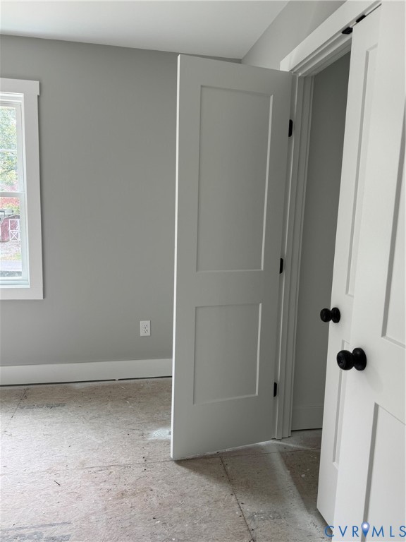 Interior featuring neutral-toned walls, two-panel shaker-style interior doors, and matte black hardware