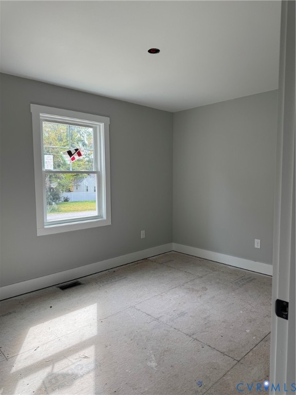 Neutral wall tones, single-hung window with crisp white trim, and ceiling-mounted electrical junction box