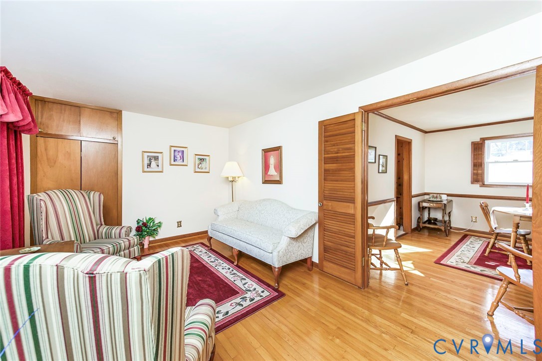 Wood-finish flooring, louvered interior doors, and built-in floor-to-ceiling wooden cabinetry