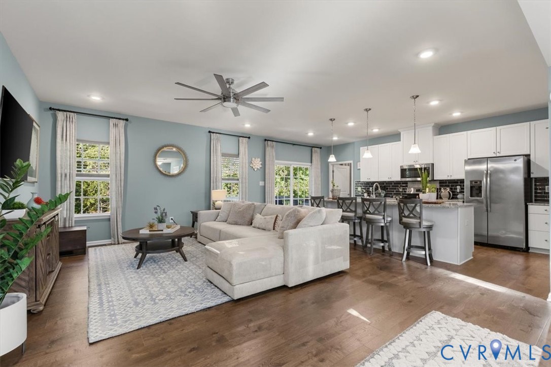 Open Concept living room.  Recessed Lights and ceiling fan, new scratch proof high end LVP