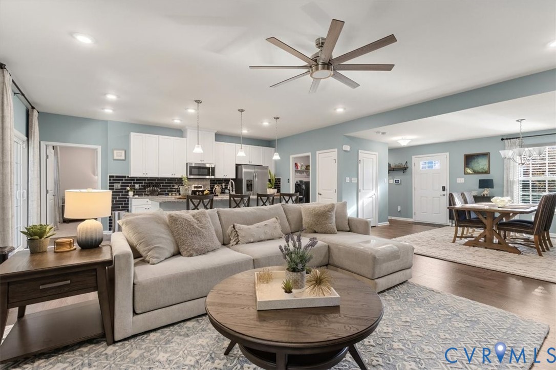 Open Concept living room.  Recessed Lights and ceiling fan, new scratch proof high end LVP