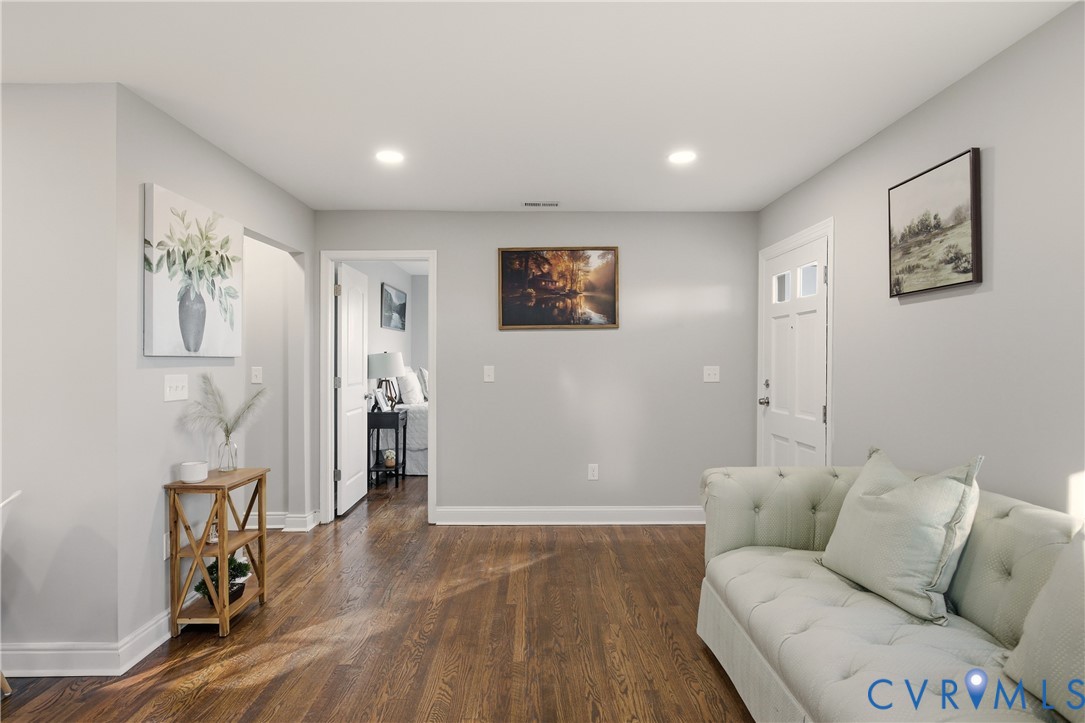 Interior space featuring wood-finish flooring, recessed lighting, and a paneled entry door with glass inserts