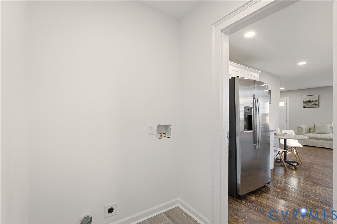 Utility area with dedicated water and electrical hookups, wood-finish flooring, and recessed ceiling lighting