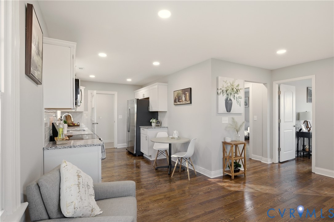 Kitchen featuring white cabinetry, stone-finish countertops, recessed lighting, and wood-finish flooring