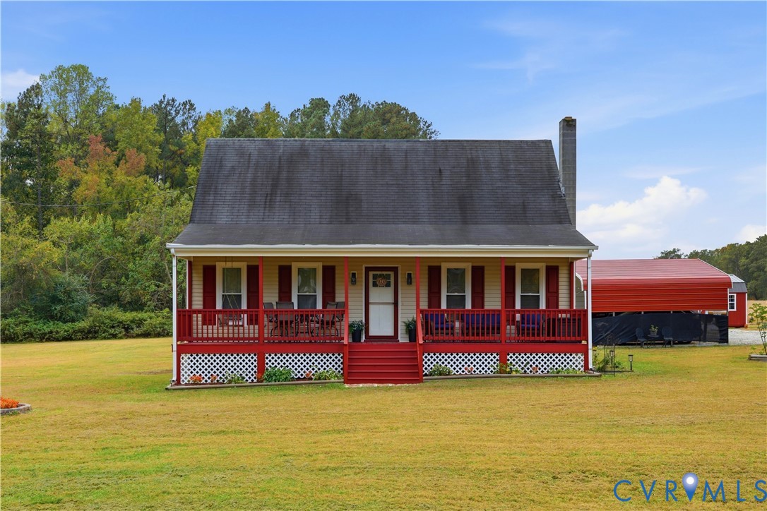 Single-story residence featuring a covered front porch with red railings, lattice foundation skirting, exterior shutters, and an attached chimney