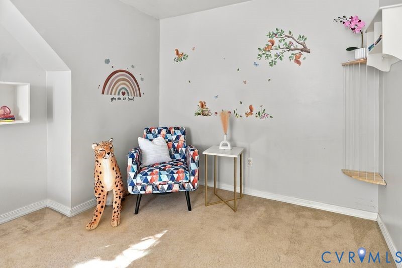 Wall-mounted white shelving, neutral carpeting, and architectural corner nook
