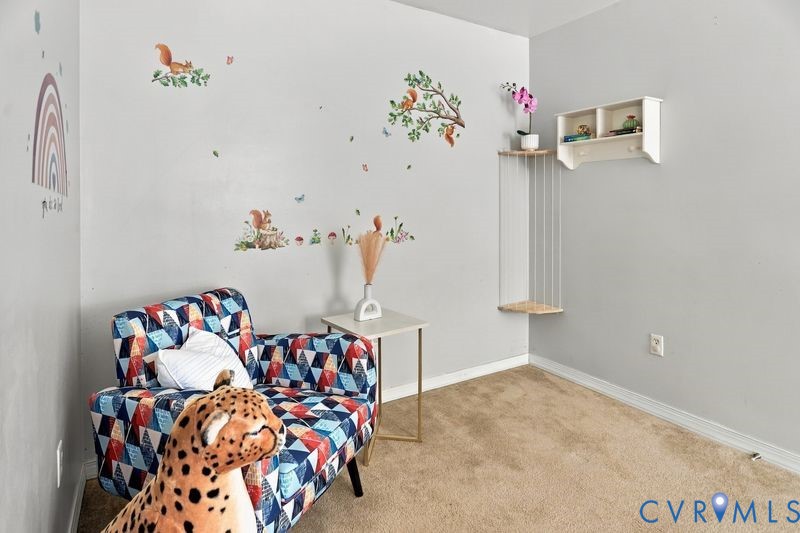 Wall-mounted white shelving unit with integrated pegs and suspended corner shelving, set against neutral-toned walls with wall-to-wall carpeting