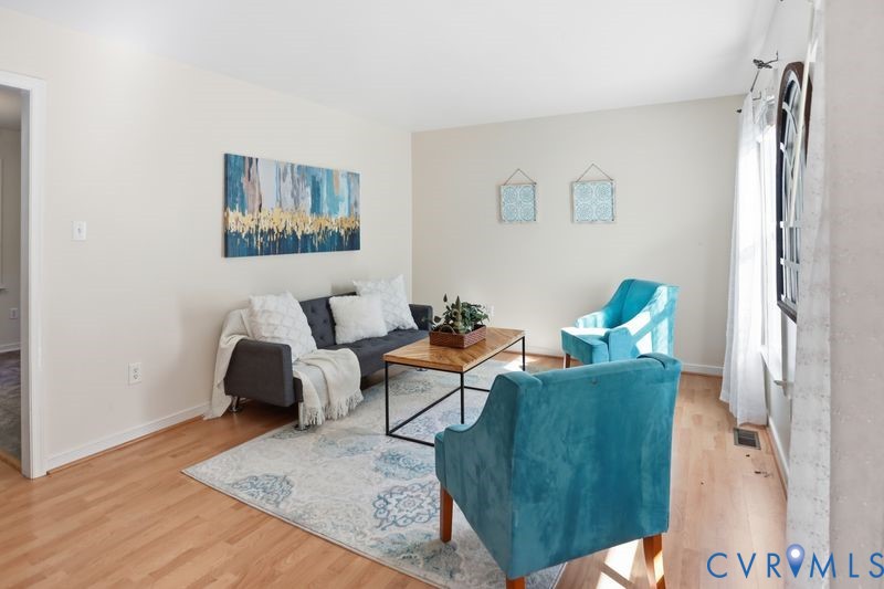 Living area featuring wood-finish flooring and neutral wall color