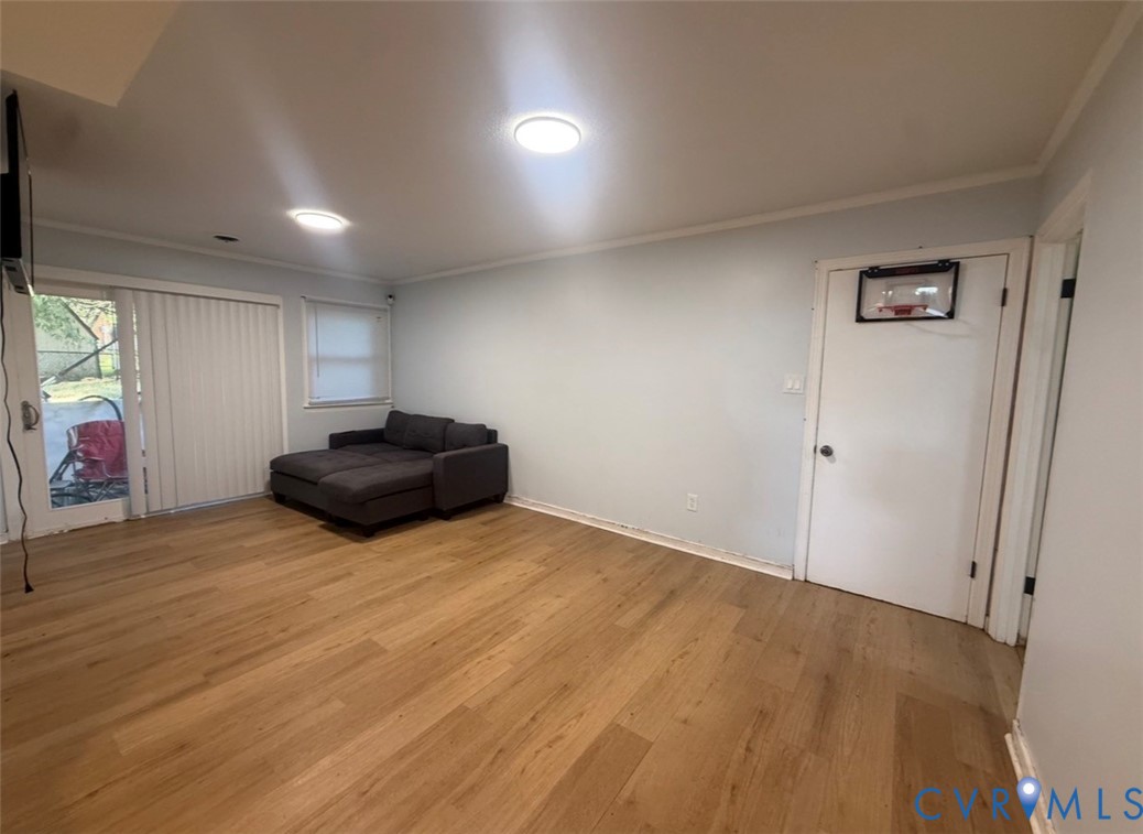 Interior space featuring wood-finish flooring, recessed ceiling lighting, and a sliding glass door