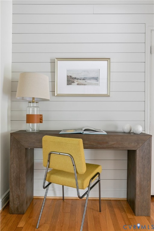 Horizontal shiplap wall paneling paired with wood-finish flooring
