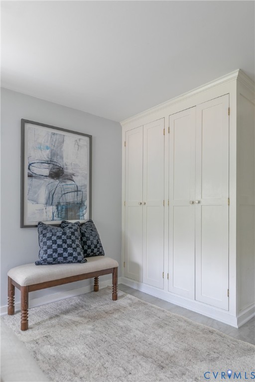 Floor-to-ceiling built-in cabinetry featuring shaker-style panel doors and crown molding