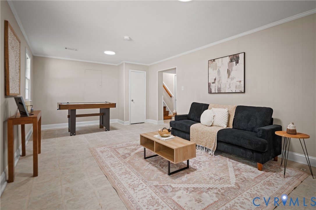 Neutral-toned interior space featuring light tile flooring, recessed ceiling lighting, and a circular skylight