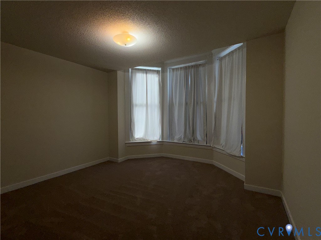 Bay window faces the street and has blackout curtains