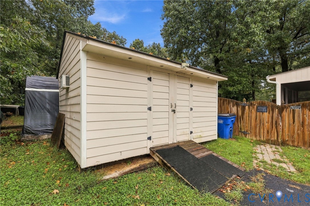 Storage structure with horizontal siding, double-door entry, and a dedicated ramp