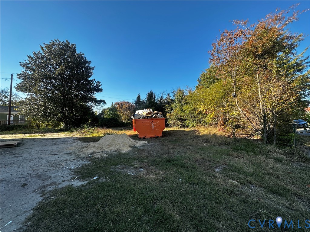 Cleared parcel of land featuring mature trees and established perimeter vegetation