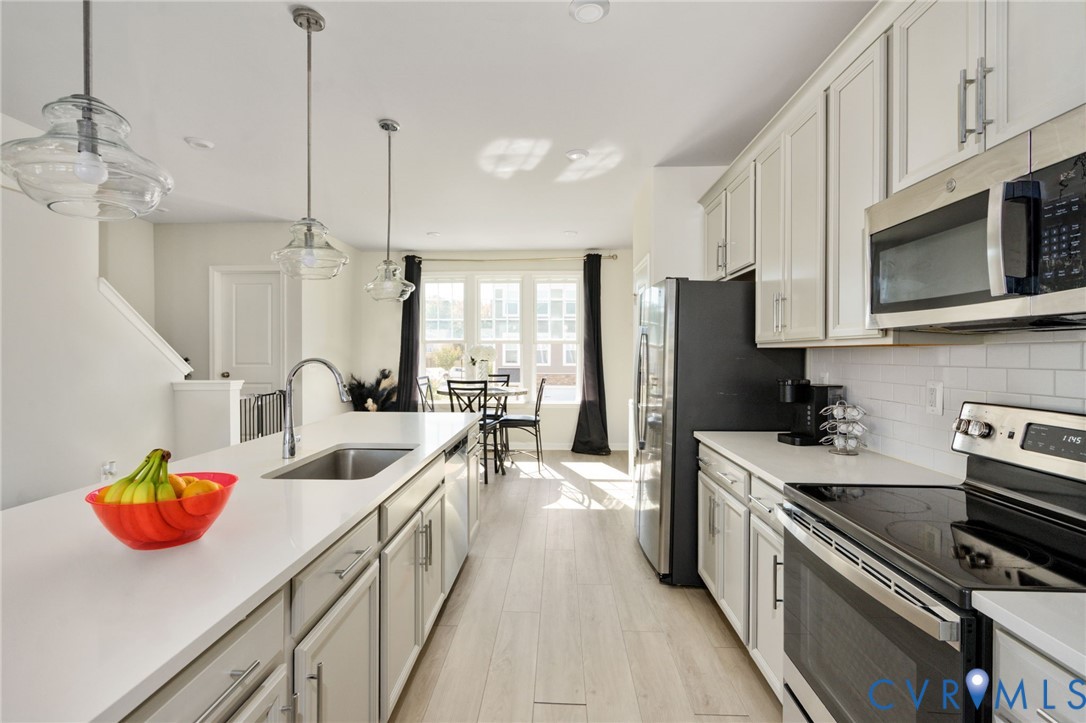 This view highlights the kitchens generous island workspace, built-in dishwasher, and abundant cabinet storage, with easy access to the adjoining dining area. This view highlights the kitchens generous island workspace, built-in dishwasher, and abundant cabinet storage, with easy access to the adjoining dining area.