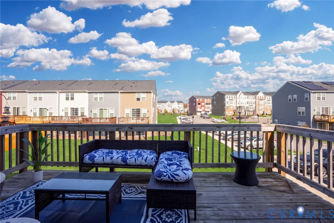 The spacious rear deck offers an inviting spot for morning coffee, outdoor lounging, or catching up with friends.
