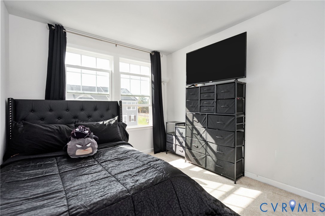 Natural light fills the third bedroom, offering a comfortable space with neutral finishes ready for your personal style.