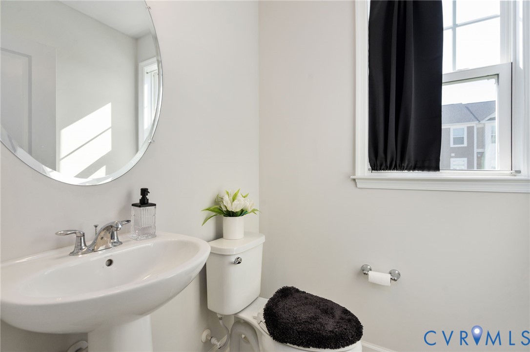 Conveniently located off the first-floor bonus room, this half bath features a pedestal sink and neutral finishes. Conveniently located off the first-floor bonus room, this half bath features a pedestal sink and neutral finishes.