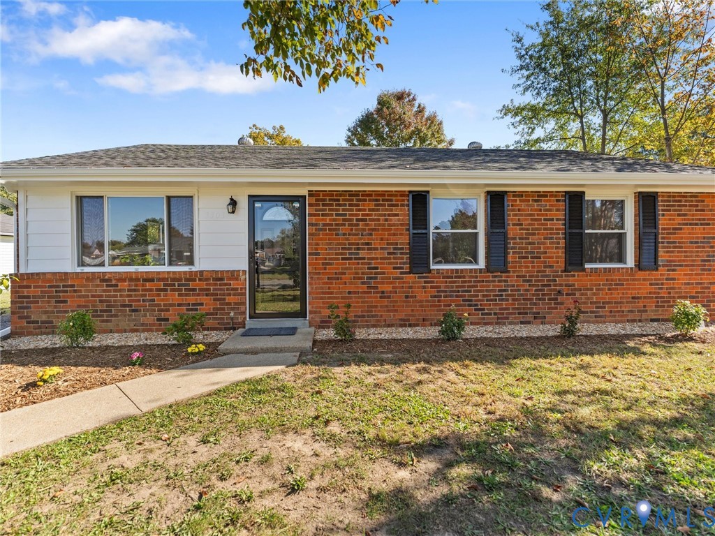 Single-story brick exterior featuring horizontal siding accents, dark shutters, a front entry with glass storm door, and a shingled roof Single-story brick exterior featuring horizontal siding accents, dark shutters, a front entry with glass storm door, and a shingled roof