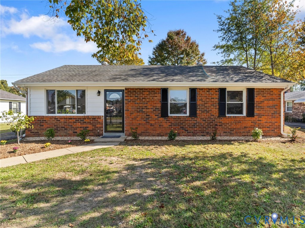 Single-story ranch exterior featuring a brick and siding facade, asphalt shingle roof, dark window shutters, and a front entry door with a decorative glass insert Single-story ranch exterior featuring a brick and siding facade, asphalt shingle roof, dark window shutters, and a front entry door with a decorative glass insert