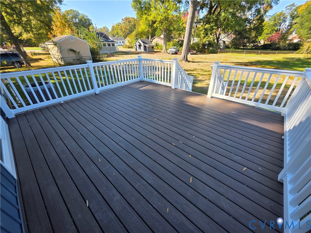 Elevated composite deck featuring white railings and staircase Elevated composite deck featuring white railings and staircase