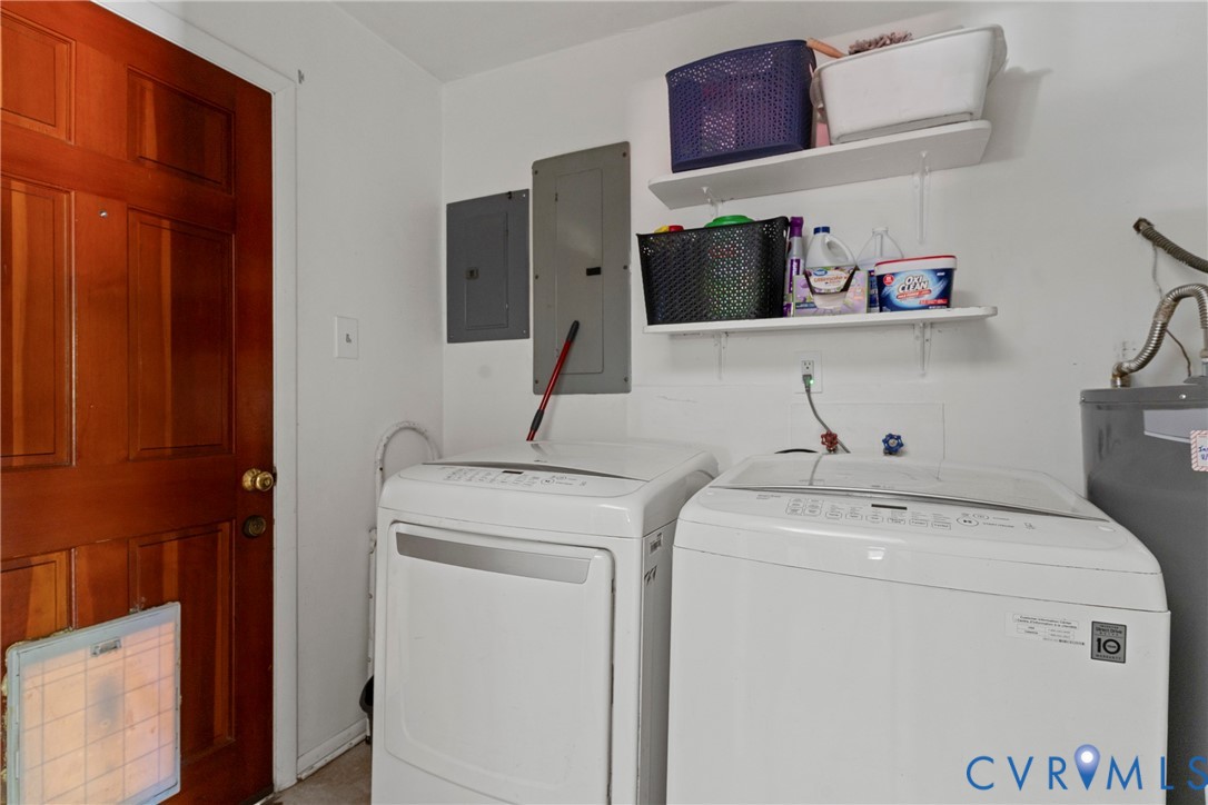 Solid wood door featuring a built-in pet portal, dual white wall-mounted shelving units, and dedicated laundry utility connections Solid wood door featuring a built-in pet portal, dual white wall-mounted shelving units, and dedicated laundry utility connections