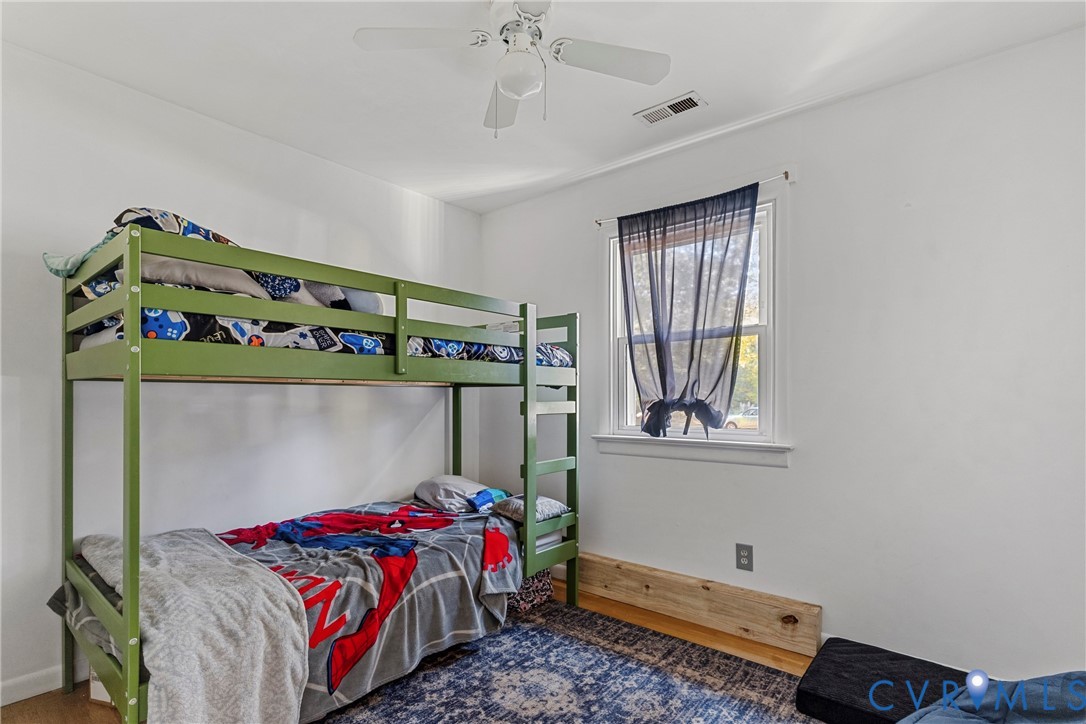 Neutral-toned room featuring a single-hung window with white casing, a white ceiling fan with integrated lighting, and light-toned hard-surface flooring Neutral-toned room featuring a single-hung window with white casing, a white ceiling fan with integrated lighting, and light-toned hard-surface flooring