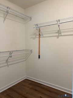 Walk-in closet featuring wood-finish flooring and multi-level white wire shelving